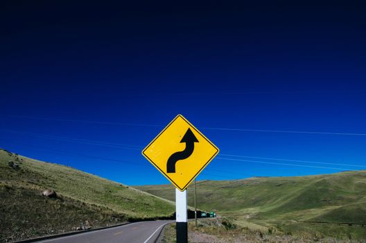 Curve sign on a highway on the way to Ayacucho - Peru