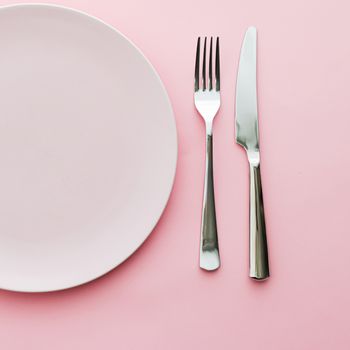 Empty plate and cutlery as mockup set on pink background, top tableware for chef table decor and menu branding design