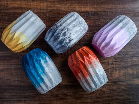 Cactus pot. Concrete pot. Empty colorful concrete planters on wooden background, top view.