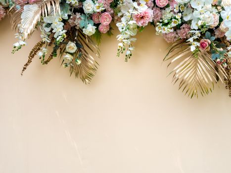 Celebration decoration background with gold tropical palm leaves with white and pink roses flower bouquet with copy space.