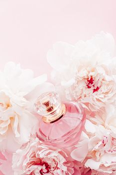 Luxe fragrance bottle as girly perfume product on background of peony flowers, parfum ad and beauty branding design