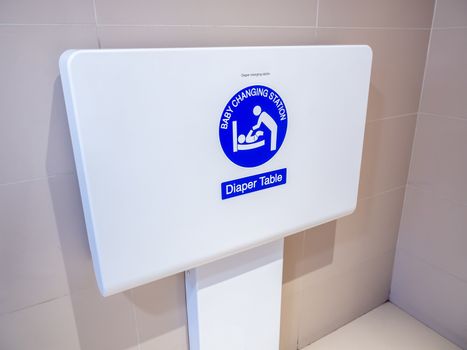 White diaper table changing station on the wall for baby changing diaper to facilitate to children parents in the airport.