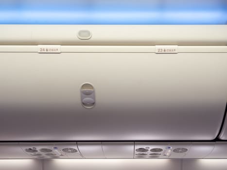 Hand-luggage compartment number 23 and 24 in cabin economy class on the low cost commercial airplane.