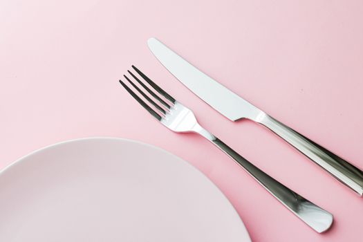 Empty plate and cutlery as mockup set on pink background, top tableware for chef table decor and menu branding design