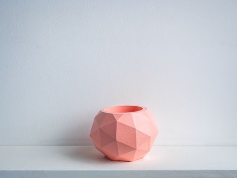 Cactus pot. Concrete pot. Empty pink modern geometric concrete planter on white wooden shelf isolated on white background.