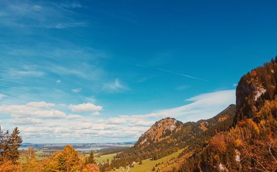 Beautiful nature of European Alps, landscape view of alpine mountains, lake and village in autumn season, travel and destination scenery