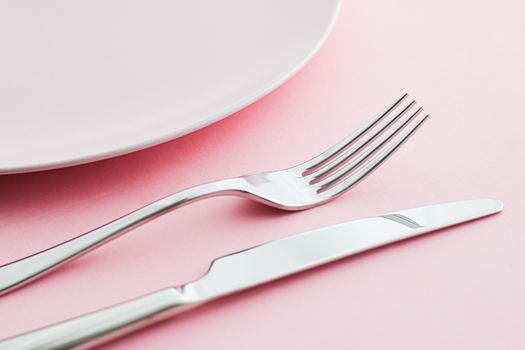 Empty plate and cutlery as mockup set on pink background, top tableware for chef table decor and menu branding design