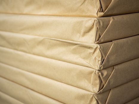 Stack of brown paper packaging. Close-up side of corner of wrapping packaging.