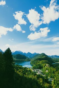 Beautiful nature of European Alps, landscape view of alpine mountains, lake and village in spring season, travel and destination scenery