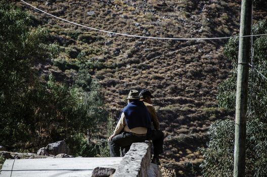 Two village man resting on the top of a mountain