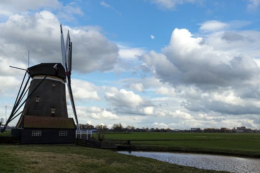 Dutch windmill facing the wind and running the turbine to pump the water out from the lands