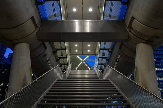 Abstract symmetric pattern staircase against an early blue sky