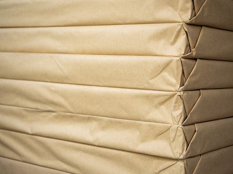 Stack of brown paper packaging. Close-up side of corner of wrapping packaging.