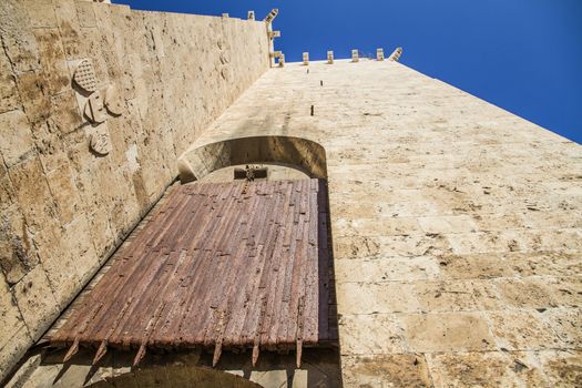 Ancient wooden rolling shutter gate with metal reinforcements at the entrance to the historical center of Cagliari in Italy