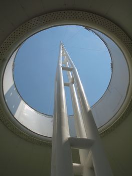 Modern architecture of a mast emerging out of a circular opening
