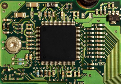 Closeup of an integrated electronic circuit board with a large processor chip
