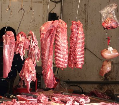 Butcher selling pork at a market in Taiwan
