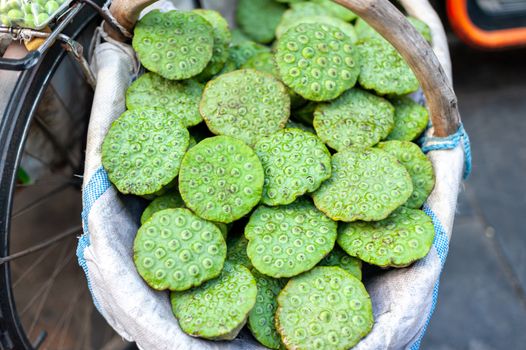 Green lotus pods in a basket in a street market in Xi'an, Shaanxi province, China