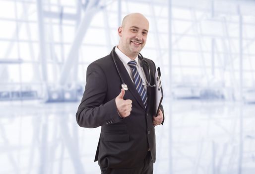 happy male doctor going thumb up, at the hospital