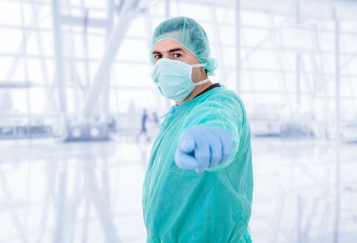 male doctor pointing at the hospital