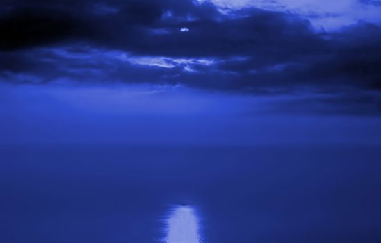 Dramatic sky over the Taiwan Strait with moonlight reflecting in the sea