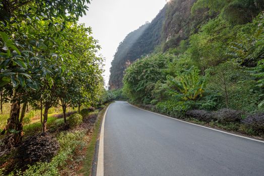 Empty road with karst hills in the background in Yangshuo, Guilin, Guangxi province, China