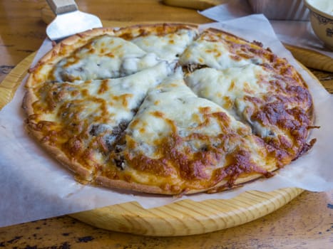 Pizza close-up view on a wooden table