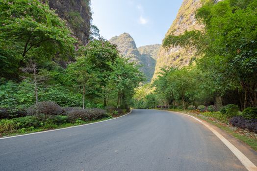 Empty road with karst hills in the background in Yangshuo, Guilin, Guangxi province, China