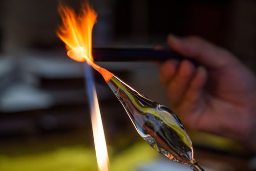 Artist works on glass with fire close-up view in Guiling, Guangxi province, China