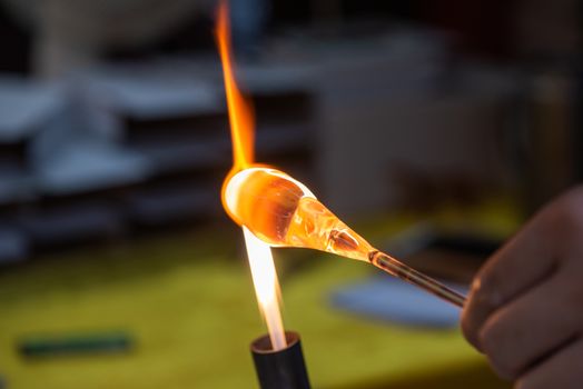 Artist works on glass with fire close-up view in Guiling, Guangxi province, China