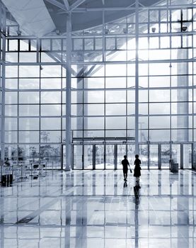 A modern corporate building detail with highly polished floors and glass and steel facade
