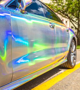 the mirrored car reflects the surrounding colors.