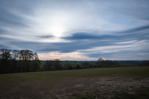 A open farmers field showing the beautiful colors in the sky
