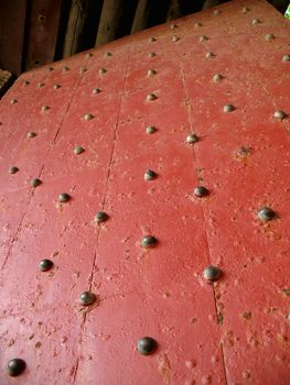 -- this gate door with large bronze nails guards the entrance to an old fort
