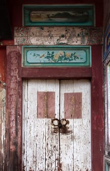  An antique painted door to a deserted Chinese residence
