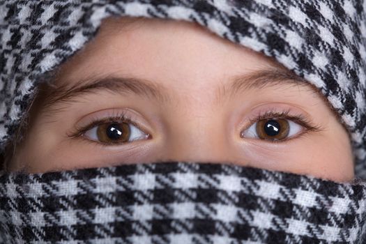 young girl with a veil covering her, close up, studio picture