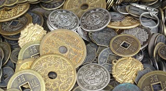 A street vendor sells imitations of old Chinese coins and currency
