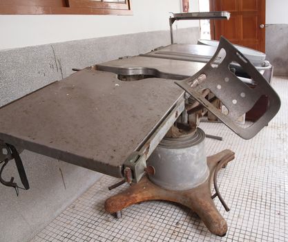 Old medical operating table dating back about fifty years
