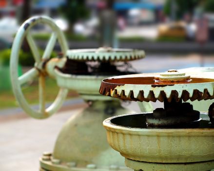 Old cogwheels that are part of an industrial water supply installation