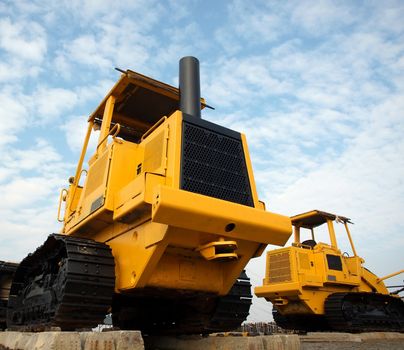 Heavy earth moving machinery is resting on concrete sleepers