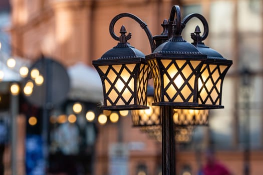 Riga, Latvia, ancient lanterns isolated against a blurry street landscape
