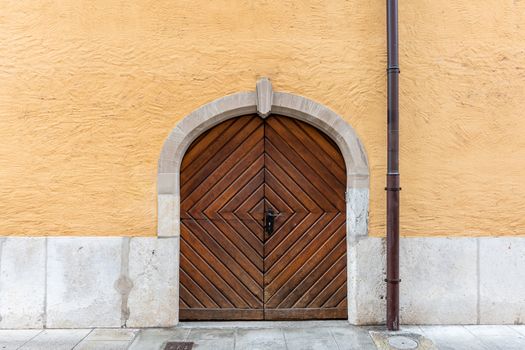 Old wooden door on the wall of an old building in Geneva, Switzerland - image