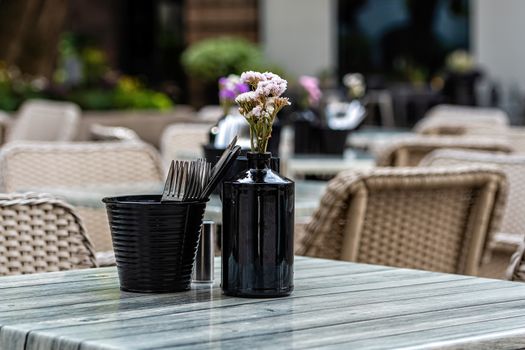 Close up shot of empty cafeteria or restaurant tables with chairs on street - image