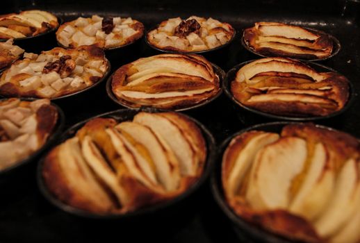 Small homemade apple pies freshly baked each in its mold