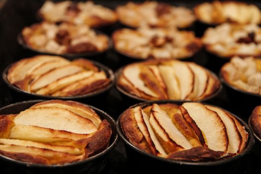 Small homemade apple pies freshly baked each in its mold