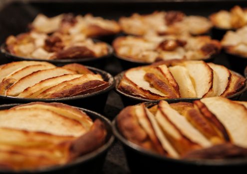 Small homemade apple pies freshly baked each in its mold