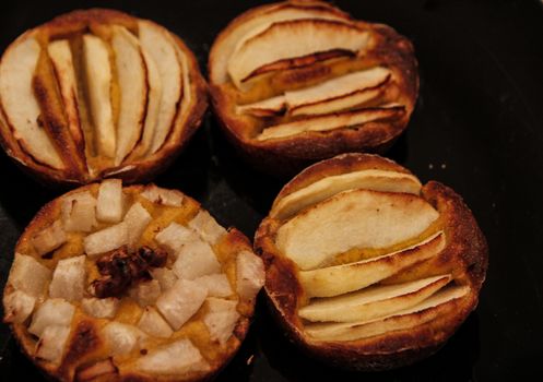 Small homemade apple pies freshly baked each in its mold