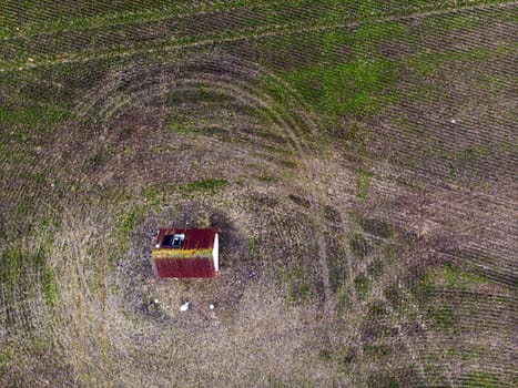 Top view of a farm field and a lone water supply farmhouse in the middle of the field, background concept for agriculture