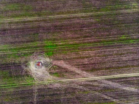 Top view of a farm field and a lone water supply farmhouse in the middle of the field, background concept for agriculture