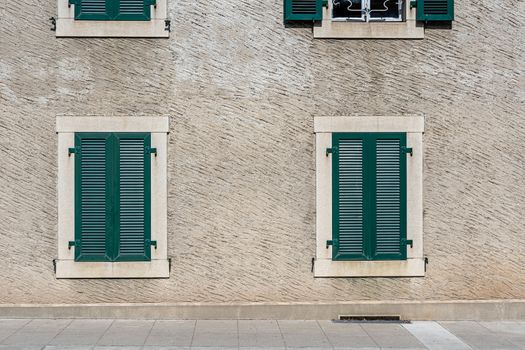 Facade of a stone house with green shutters. Swiss - French border - image